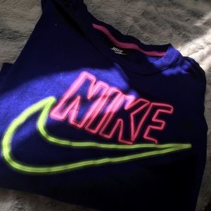 purple crop top with a neon Nike symbol
